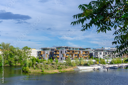 modern architecture residential building condominium appartments development cloud with small boat marina