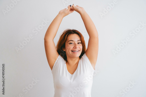 young latin woman pluz size smiling looks at camera confidant of herself
