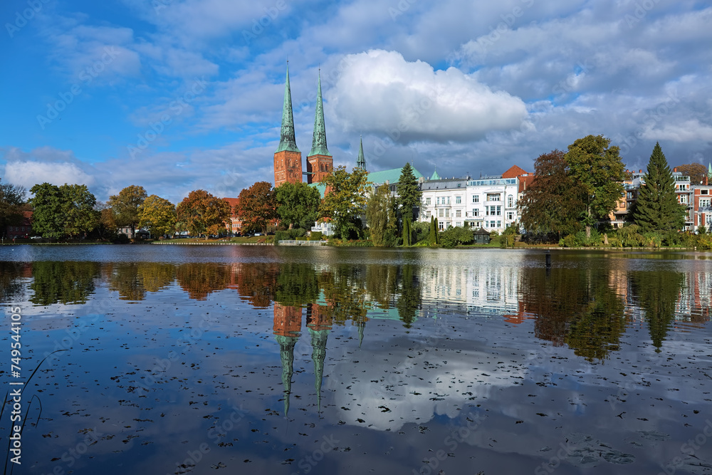 Lubeck, Germany. View of Lubeck Cathedral from the opposite shore of Muhlenteich (Mill pond) in autumn day. The cathedral was started in 1173 and consecrated in 1247.