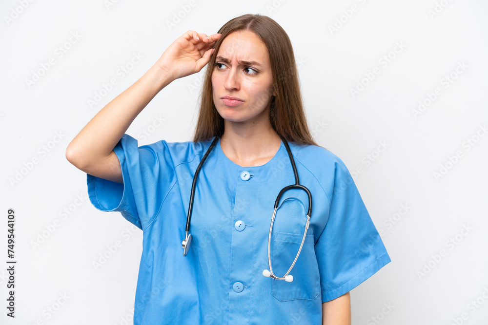 Young nurse woman over isolated on white background having doubts and with confuse face expression Young nurse woman over isolated on white background having doubts and with confuse face expression