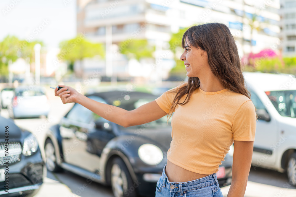Young woman at outdoors holding car keys