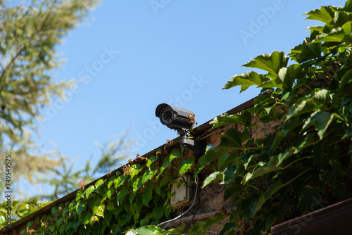 Video surveillance camera on blue sky background....