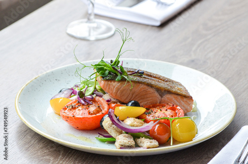 grilled fish salmon with vegetables, color food, healthy, tomatoe, olive, fresh food, serving , restaurant photo