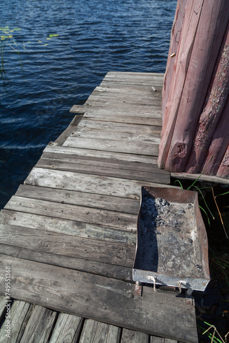 Metal brazier on wooden platform above river