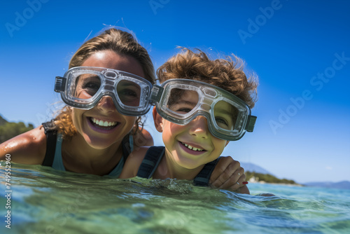 Mother and son at beach with diving goggles © luismolinero