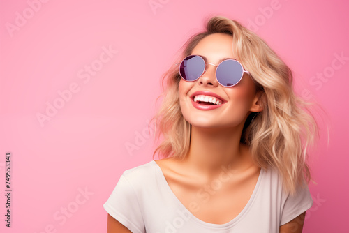 Young pretty blonde girl over isolated colorful background with sunglasses