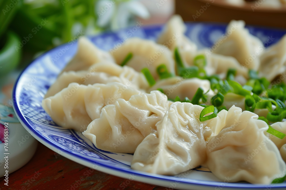 A plate of wontons, a type of Chinese dumpling commonly found across regional styles of Chinese cuisine.