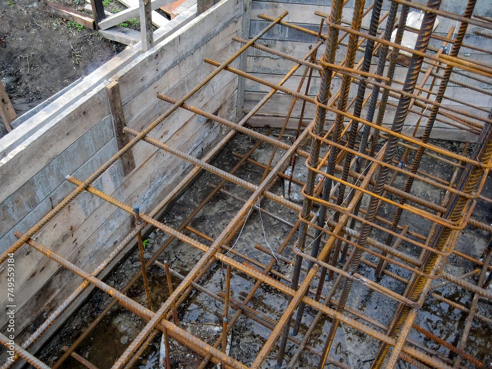 Building process, installing rebar grids for concrete foundation, detailed view.