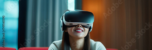 Asian Chinese young woman using virtual reality smart glasses in virtual space. Young beautiful woman wearing a VR headset and experiencing virtual reality. Banner copy space. Trendy virtual reality