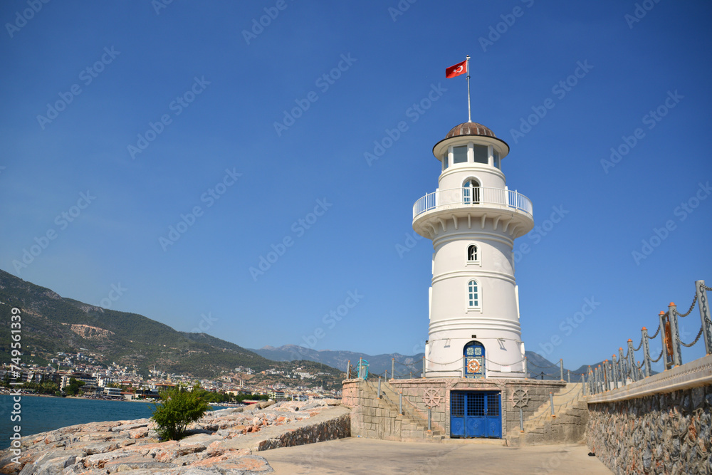 white lighthouse on the seafront isolated copy space 