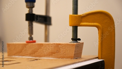 Wooden block clamped with clamps, woodworking, handicrafts