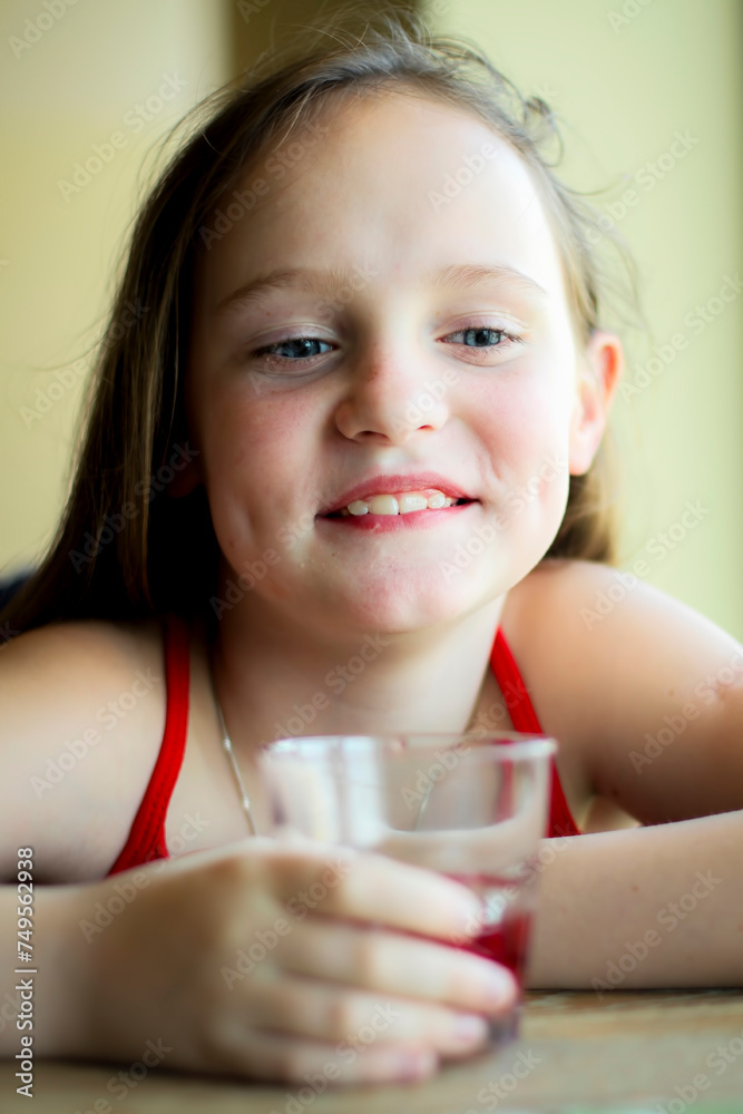 A teenage girl in a cafe with a glass of juice. A teenage girl in a cafe with a glass of juice.