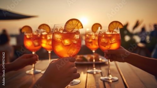 glasses of aperol spritz. Friends clinking glasses of Aperol spritz cocktails, People are holding glasses of aperol.