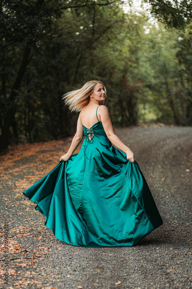 Beautiful blonde lady woman in green dress spinning Beautiful blonde lady woman in green dress spinning