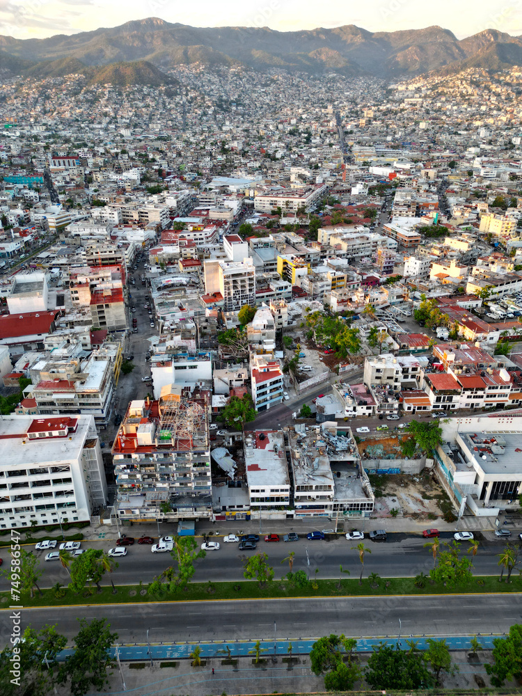 High-angle vertical photograph capturing the vibrant and bustling center of Acapulco, showcasing its dense urban landscape