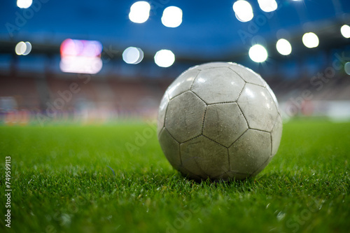 White soccer ball lying on the grass at stadium © Dziurek