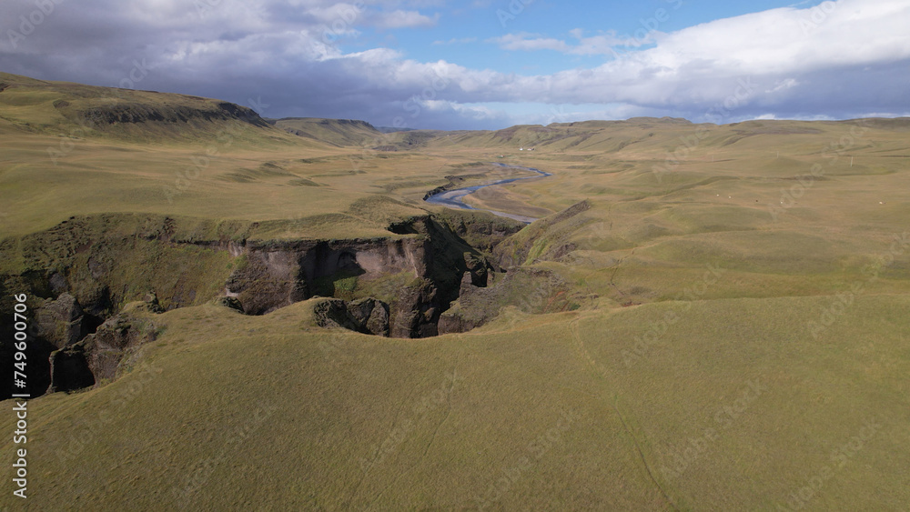 Fjadrargljufur (or Fjadra Canyon) is a 100 m deep and about 2 kilometres long serpentine canyon with the Fjaðrá river flowing through it, South Iceland. Fjadrargljufur (or Fjadra Canyon) is a 100 m deep and about 2 kilometres long serpentine canyon with the Fjaðrá river flowing through it, South Iceland.