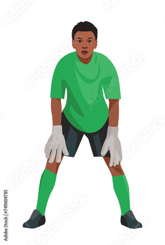 Angolan teenage boy goalkeeper of junior football teem in green uniform and gloves who stands upright in goal and waits for the ball