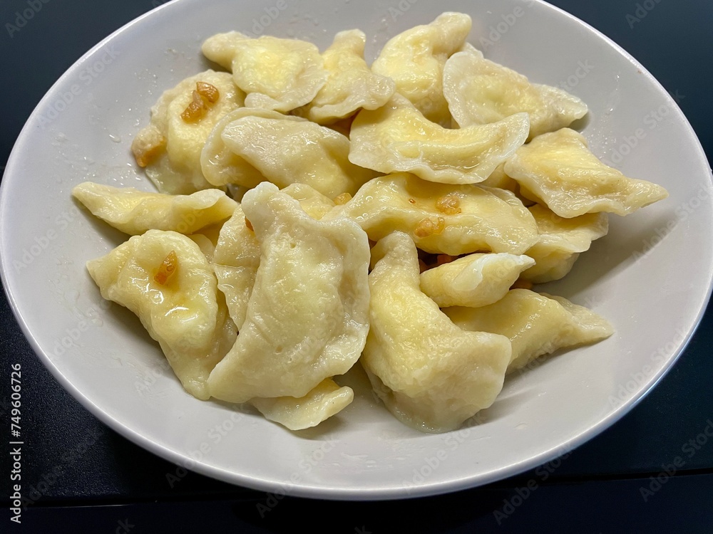 Dumplings with cheese on a gray plate