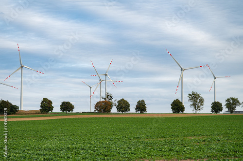 A wind farm with an agricultural field in the foreground