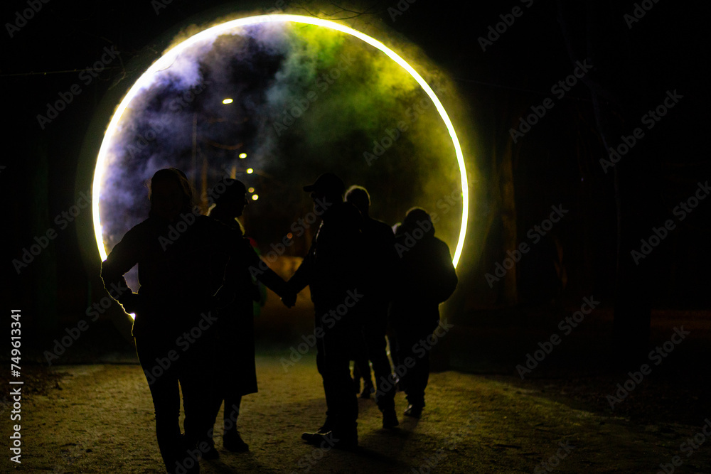 Illuminated portal with fog and smoke in the middle of the road