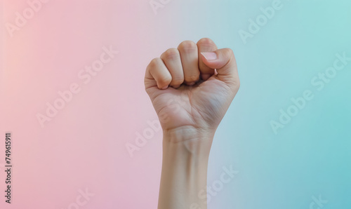clenched fist raised in determination on a soft pastel gradient background