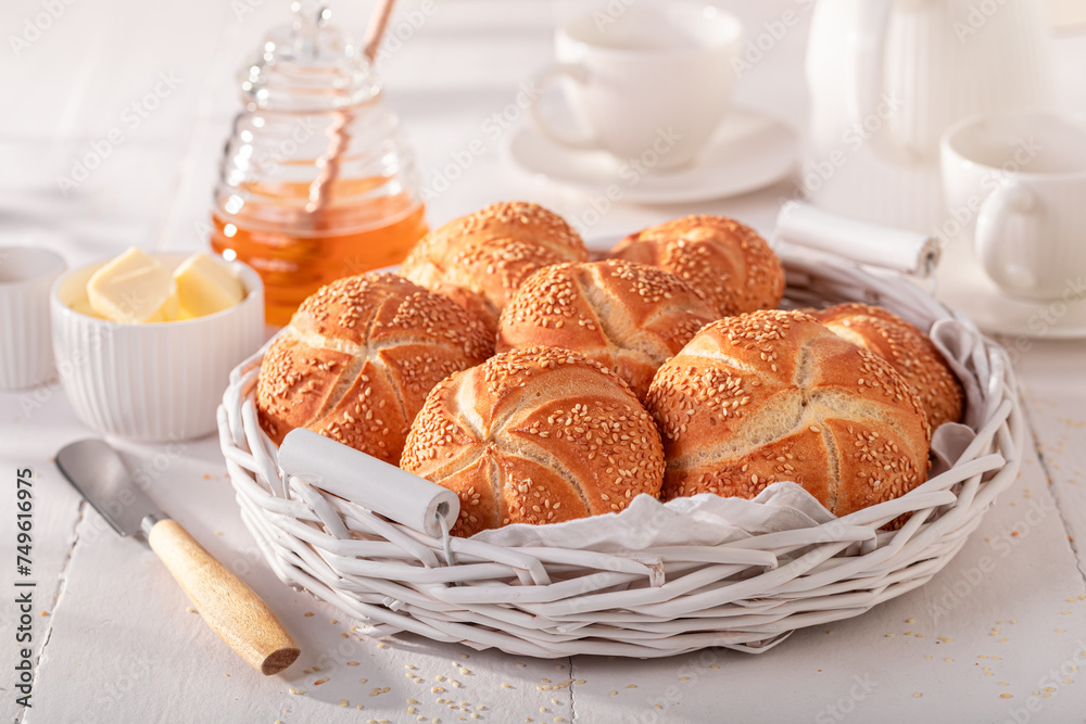 Healthy Kaiser rolls with sesame seeds, butter and honey. Healthy Kaiser rolls with sesame seeds, butter and honey.