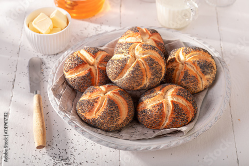 Homemade Kaiser buns with poppy seed baked for golden brown. photo