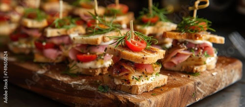 A wooden cutting board is filled with delicious mini sandwiches made with whole 100g bread, creating a visually appealing display of bite-sized delights ready to be enjoyed.