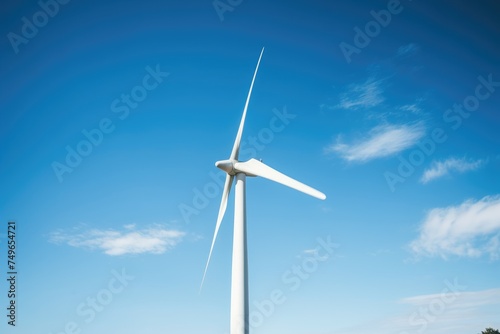 Close-up of Wind Turbine Blade and Sky. Upward angle of a wind turbine blade against a serene blue sky, representing renewable energy