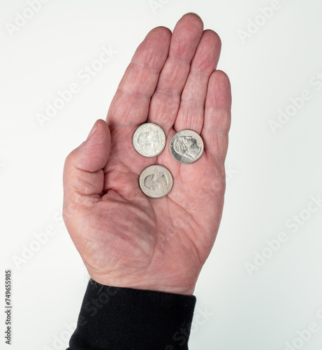Slika na platnu Man's open hand holding three U.S. quarter dollar coins in palm