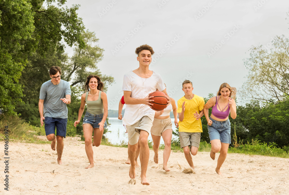 a group of young students having fun in nature a group of young students having fun in nature
