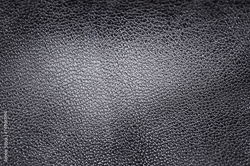 Black genuine leather soft focus in the center of the frame. Leather material as background.