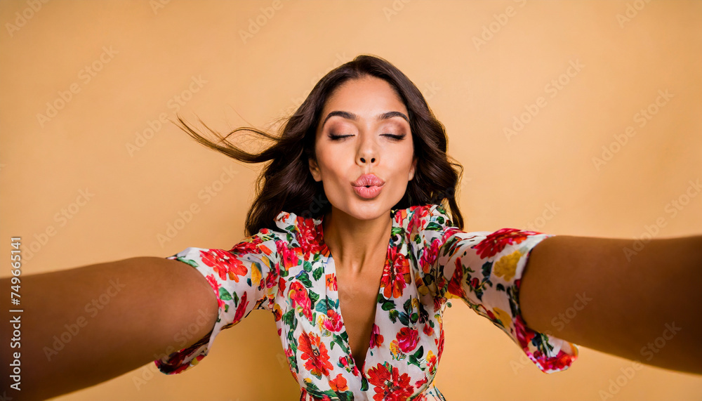 Selfie of flirty sweet lady in flower printed clothes sending a kiss - obrazy, fototapety, plakaty 