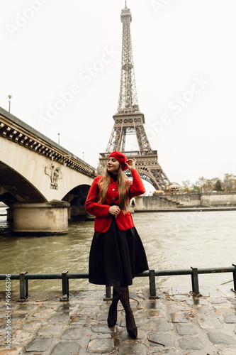 happy young girl in a red beret posing in front of the elf tower in the autumn season. visit to Paris. vertical photo.city of romance. walk in Paris.