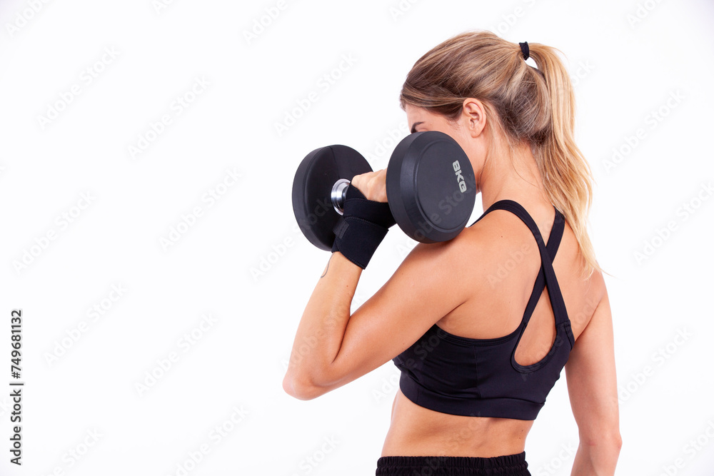 Sports girl with dumbbells in her hands on a light background Sports girl with dumbbells in her hands on a light background