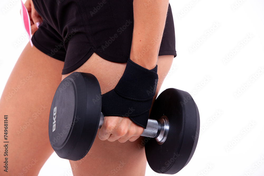 Dumbbell in a woman's hand close up Dumbbell in a woman's hand close up