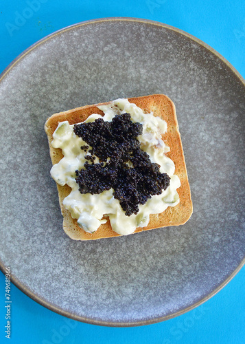 Toasted bread with Tzatziki and black lumpfish caviar photo