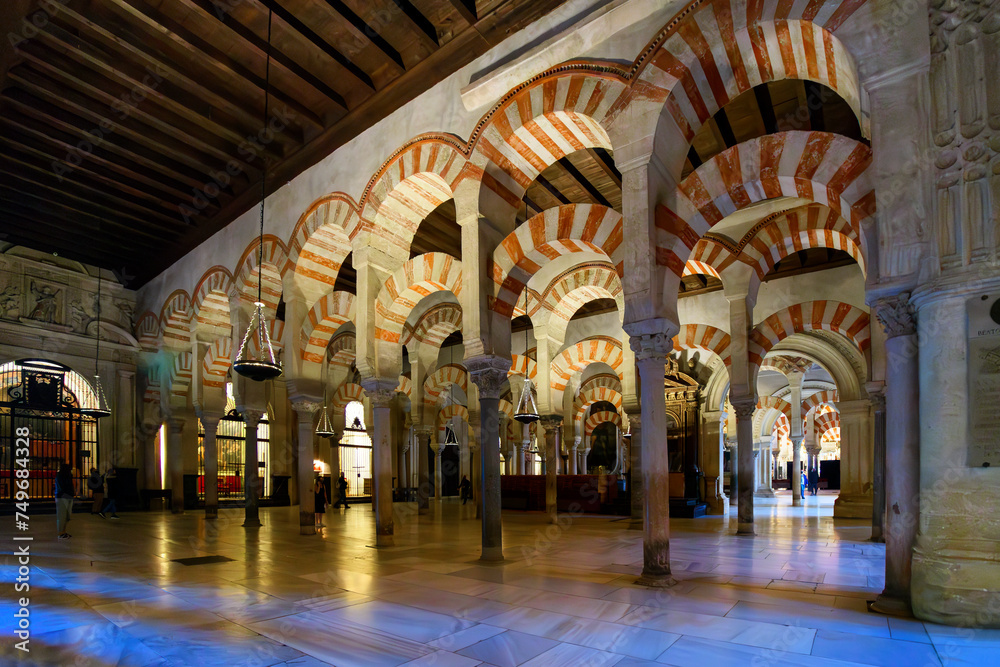 Inside the ornate and arched Hypostle Prayer Hall of the great Mosque Cathedral Mezquita in the medieval city of Cordoba, Spain, in the Andalusian region.