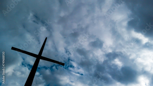 Wooden cross on the left side with sky in the background in Bogotá