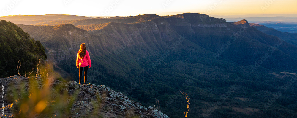 beautiful hiker girl enjoying sunset over unique, folded mountains in south east queensland, australia; main range national park near brisbane, bare rock lookout - obrazy, fototapety, plakaty 