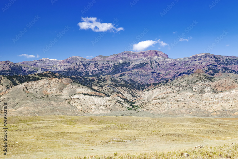 Panoramic summer landscape view of the south fork Shoshone Valley environment of mountains, canyons, hills and clear blue sky in northwest Wyoming, USA.