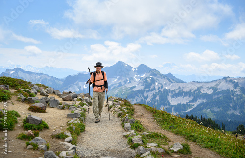 Front view of a man hiking at Skyline Loop Trail. Mt Rainier National Park. Washington State.