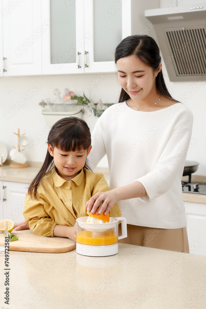 Asian mother making fresh juice with her daughter Asian mother making fresh juice with her daughter