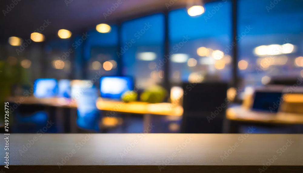 Empty wooden desk table display with a blurred modern office background with computers on desks, illuminated by evening lights. Empty wooden desk table display with a blurred modern office background with computers on desks, illuminated by evening lights.