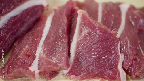 Fresh beef is sliced on natural background. Raw delicious red beef meat.