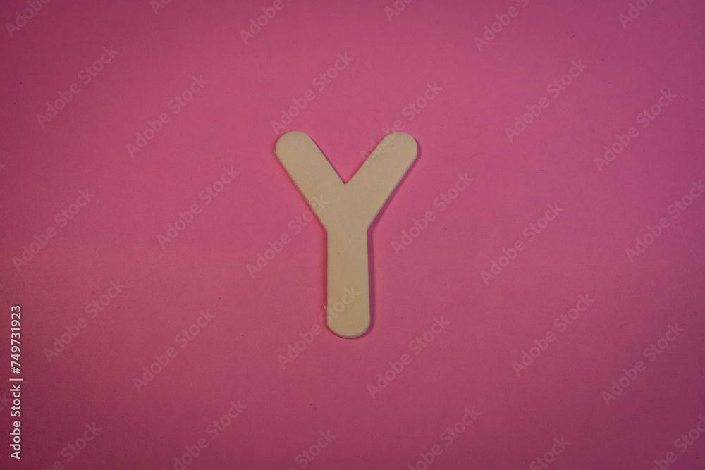 Letter Y in wood on a pink background Letter Y in wood on a pink background