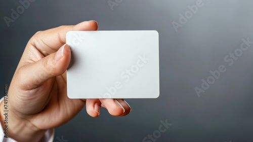 Hand hold blank white card mockup with rounded corners. Plain call-card mock up template holding arm. Plastic credit namecard display front. Check offset card design. Business branding photo