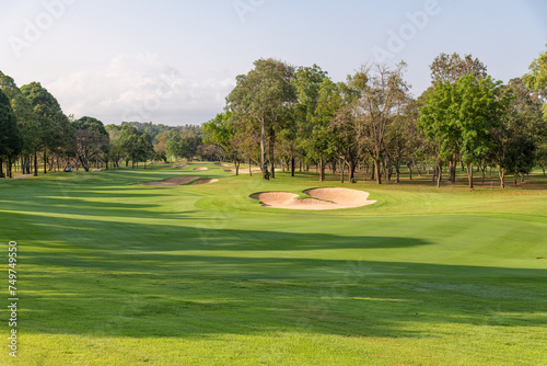 Beautiful green view at golf course ,green trees and mountain blue sky white cloud background	