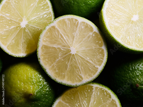 Close-up of fresh green and yellow limes, background